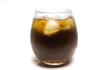 close up of a glass of iced coffee with ice cubes, isolated on a white background