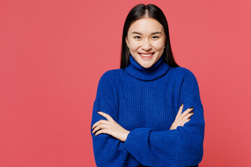 Young smiling happy woman of Asian ethnicity she wears blue sweater casual clothes hold hands...