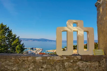 Fotobehang The Glagolitic alphabet letter L in the Stari Grad historic centre of the coastal town of Novi Vinodolski, Primorje-Gorski Kotar County, Croata. It is t © dragoncello