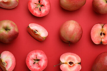 Tasty apples with red pulp on color background, flat lay
