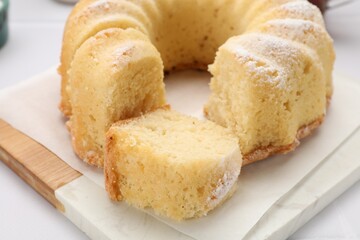 Delicious freshly baked sponge cake on white table, closeup