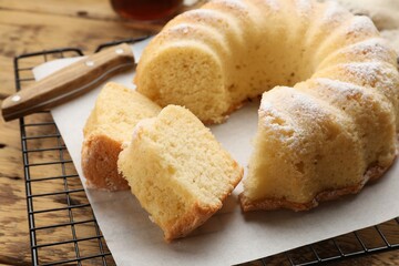 Delicious freshly baked sponge cake on wooden table, closeup