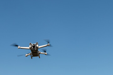 Quadcopter in flight. Unmanned aerial vehicle. Quadcopter on a blue sky background. Remote video shooting from a height. Photos and videos from above. Hobby. Intelligence equipment