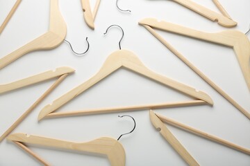 Wooden hangers on white background, flat lay