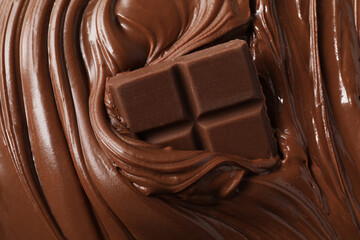 Tasty milk chocolate paste and pieces as background, top view