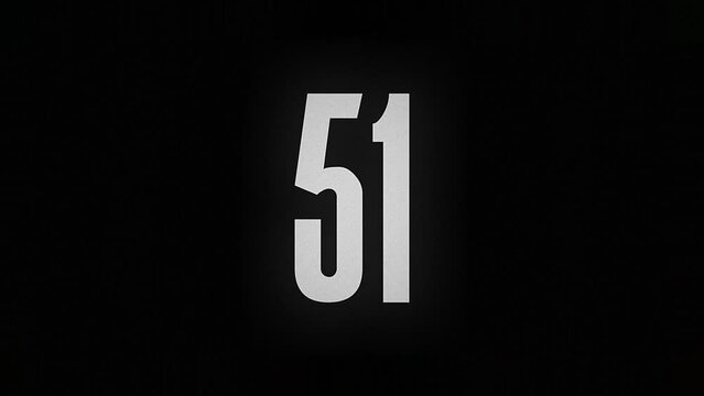 The number 51 smolders and burns on a black background, the number is on fire