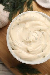 Tasty garlic sauce with dill on table, top view