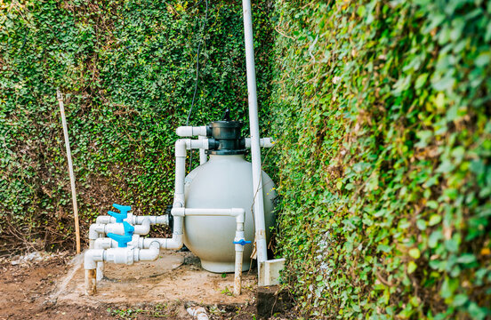 Home swimming pool filter and treatment plant installed. Pool pump with sand filter installed. Pool purification and maintenance system