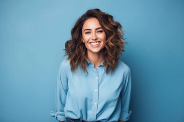 Happy young woman in a blue shirt on a blue background