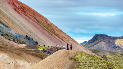 Landmannalaugar, Iceland. Panoramic over most colorful Brennisteinsalda Mount volcano and hikers....