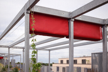 Pergola Awning in Garden Roof of Apartment Building. Modern Aluminum Fabric Rolling Pergola on Roof Terrace of Residential Neighborhood House.