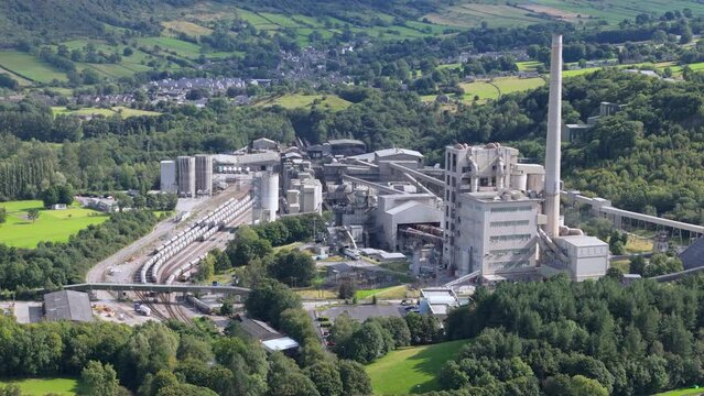 Hope cement works aerial view orbiting manufacturing factory in idyllic rolling Derbyshire countryside