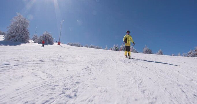 Front view pf professional skier skiing on slopes on a sunny winter day. Recorded at 120 fps on cinema camera. Ski run 04 clip 1 of 6.