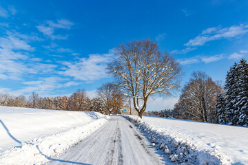 Fototapeta na wymiar Road in the countryside after heavy snowfall in central Europe