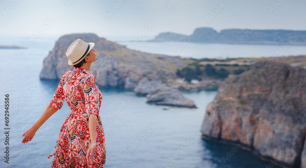 Wall mural nice happy female enjoying sunny day on greek islands. travel to greece, mediterranean islands outsi