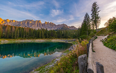 Lake Carezza in Val d'Ega, rainbow lake. Mermaid legend paints it with rainbow hues. Changing depths, frozen charm in winter