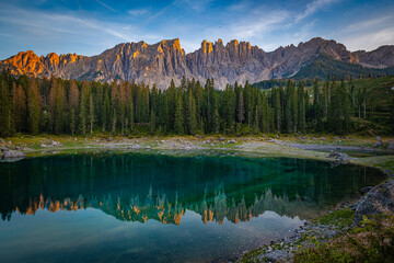 Lago di Carezza's emerald waters, misty forests, and Latemar views create an unparalleled Alpine charm