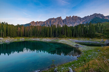 Lago di Carezza's emerald waters, misty forests, and Latemar views weave an unmatched Alpine...