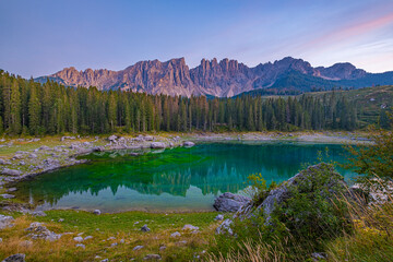 Emerald waters, misty Spruce forests, and breathtaking views, Lago di Carezza, an alpine gem in Val d'Ega. Popular among tourists and photographers
