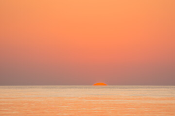 sunrise with orange sky and sun at the red sea on vacation