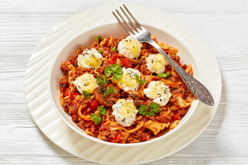 Lasagnette with ground beef in bowl, top view