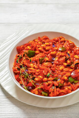 chakalaka, spicy tomato bean relish in white bowl