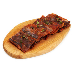 Dried beef meat, slices, meat chips on a wooden board, on a white background, isolated