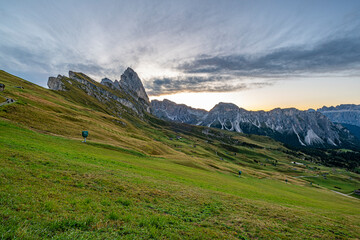 Morning's golden embrace over Seceda, Dolomites, Italy, a breathtaking sunrise paints the peaks and valleys in hues of warmth and tranquility.