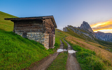 Sunrise at Seceda, Dolomites, Italy, Golden hues embrace the rugged landscape and meadows, unveiling a breathtaking morning panorama, serene and radiant in its natural beauty