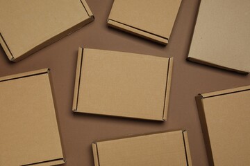 Many closed cardboard boxes on brown background, flat lay