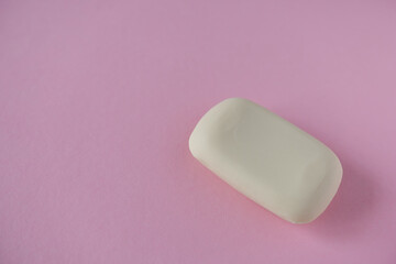 Bar of soap on a pink background. Minimalism concept. Baby soap