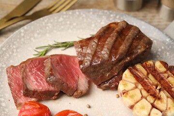 Delicious grilled beef steak with spices on table, closeup