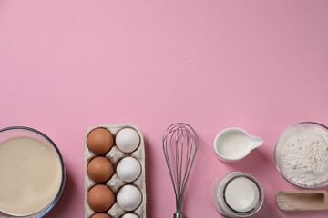 Flat lay composition with whisk and dough in bowl on pink background. Space for text