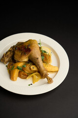 Baked duck leg with quince, potatoes and peas in sauce