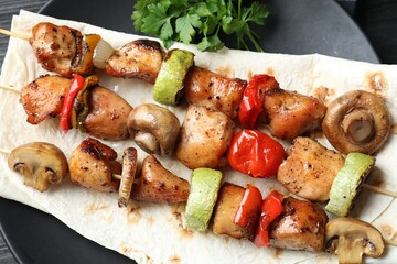 Delicious shish kebabs with vegetables on table, top view