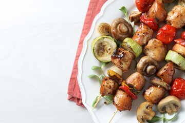 Delicious shish kebabs with vegetables and microgreens on white table, top view. Space for text