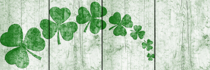 St Patricks day background. Shamrocks over a light green wood background. Decoration for St. Patrick's Day