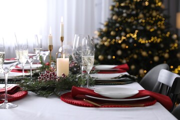 Christmas table setting with festive decor and dishware indoors