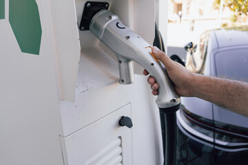Unrecognizable person using a charging station or point for electric cars.
Environment, renewable energy, ecology