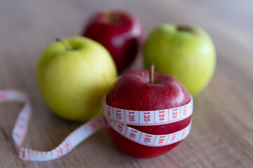 Closeup image of apple and measuring tape. Copy space for text. Diet, healthy eating, weight loss concept.