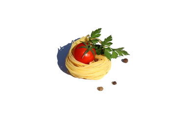On a white background there is one curled spaghetti in the form of a nest with a tomato and pepper with polka dots decorated with parsley.