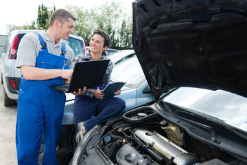 garage workers working on car diagnostic