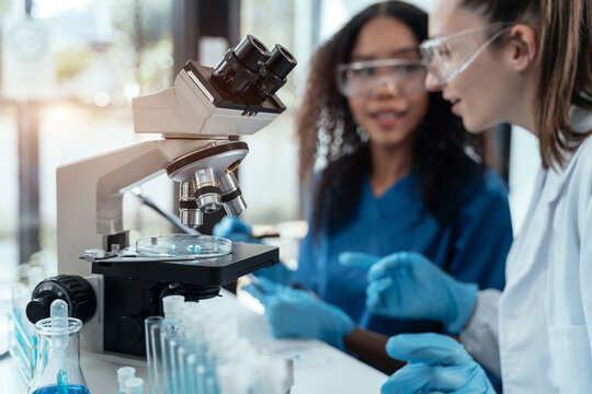 Female scientist researcher conducting an experiment working in the chemical laboratory.