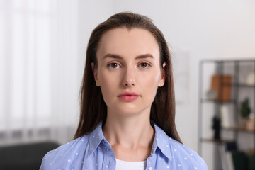 Portrait of beautiful young woman in room