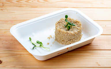 Steamed bulgur. Healthy food. Takeaway food.  On a wooden background.