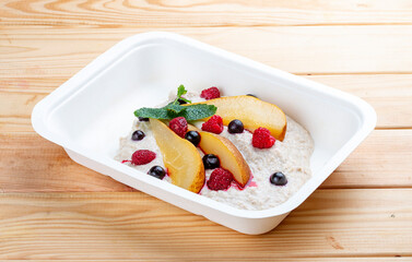 Stewed pear with curd mousse. Healthy food. Takeaway food. On a wooden background.