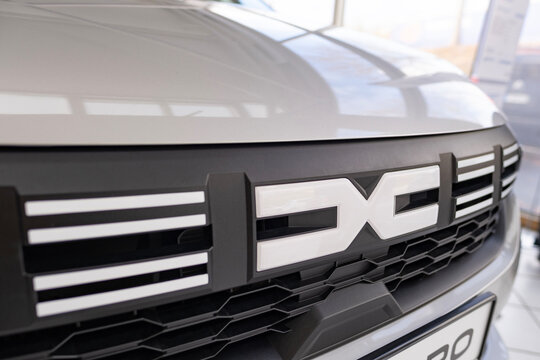 electric Dacia Spring car Logo on cap, trends EV in Europe, technological advancements automotive industry, environmental cleanliness vehicle, Frankfurt, Germany - December 13, 2023