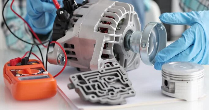 Repairman checks generator part, slow motion. Car starter upgrade, close up. Equipment for repair, warranty service