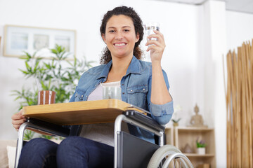 young lady in wheelchair having meal on tray