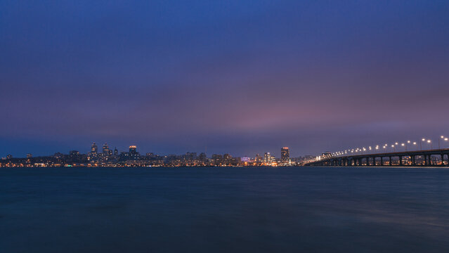 Night big city. Panoramic view of the towers, skyscrapers, promenade in the evening, the lights are reflected on the Dnieper River, Ukraine. Dnipro city. spring, autumn, summer.